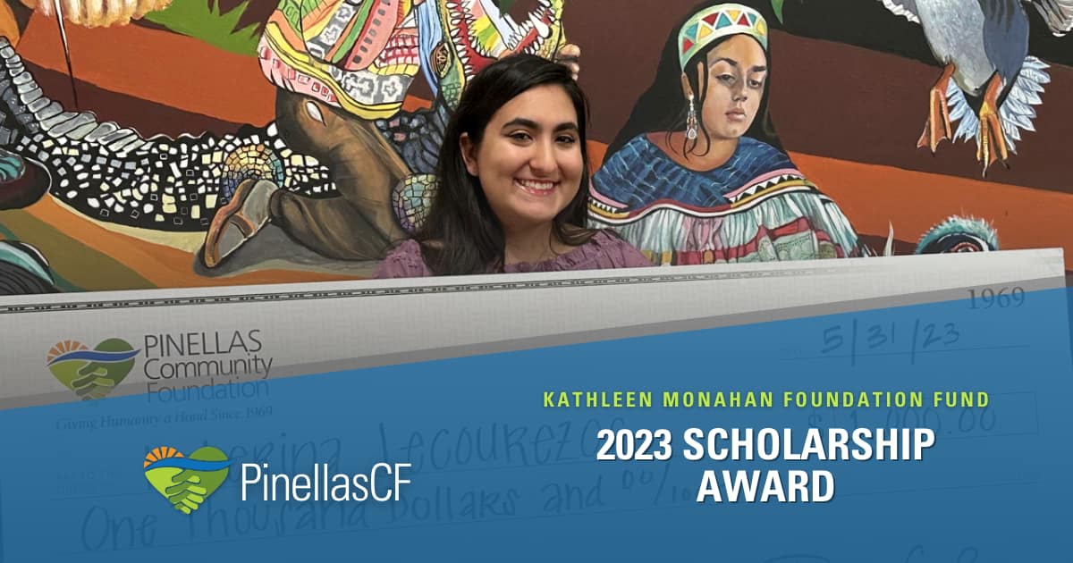 2023 Kathleen Monahan Foundation Fund Scholarship recipient Katerina Lecourezos holds an oversized check for $1,000 from Pinellas Community Foundation at a grant presentation ceremony last month at Tarpon Springs Cultural Center. She stands before a mural by Elizabeth Indianos depicting Tarpon Springs' history, including Native Americans and wildlife.