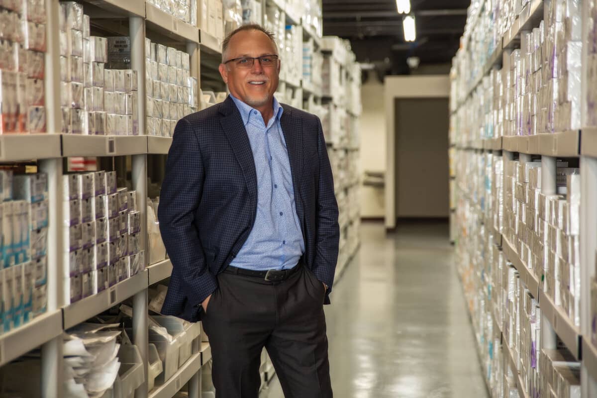 Randy Ware stands among aisles of medical supplies in the WestCMR  warehouse based in Clearwater.