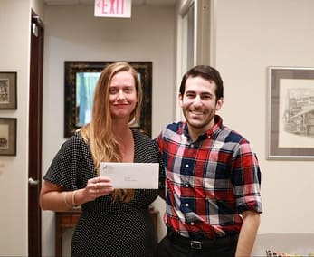 Maureen McDale of Keep St. Pete Lit accepts a grant from PCF Grant Manager David Bender.