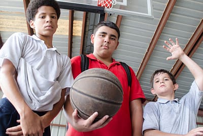 Three boys ready to play basketball.