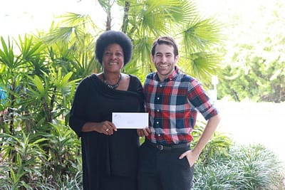 Faye Watson of DAB Community Services accepts a grant from PCF Grant Manager David Bender.